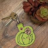 Close‑up of embroidered green cactus keychain with pink flower
