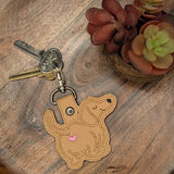 Close‑up of embroidered Dachshund keychain with heart detail