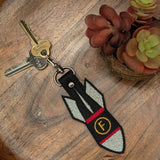 Close‑up of embroidered F‑Bomb keychain with yellow F