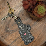 Faux leather embroidered Great Dane keyring with heart detail on wooden tray