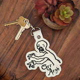 Close‑up of embroidered cult‑TV‑style creature keychain