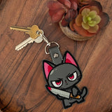 Close‑up of embroidered sword cat keychain with red eyes