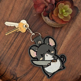 Close‑up of embroidered knife mouse keychain with pink ears