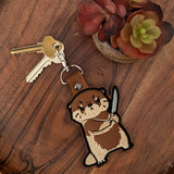Cute faux leather keyring featuring chaotic otter design