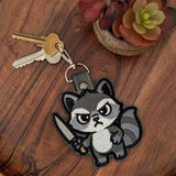 Cute faux leather keyring featuring chaotic raccoon design