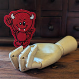 Embroidered Devil halloween finger puppet made from felt displayed on a wooden mannequin hand. 