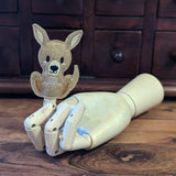 Embroidered kangaroo finger puppet made from felt displayed on a wooden mannequin hand. 