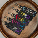 LGBTQ+ Pride keyrings featuring embroidered heart and PRIDE text