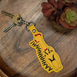 Faux leather embroidered screaming chicken keyring on wooden tray