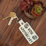 Close‑up of embroidered floral apothecary‑style keychain