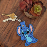 Close‑up of embroidered blue alien creature keychain with big ears
