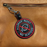 Faux leather allergy alert keychains showing dairy, eggs, peanuts, gluten, seafood, and shellfish